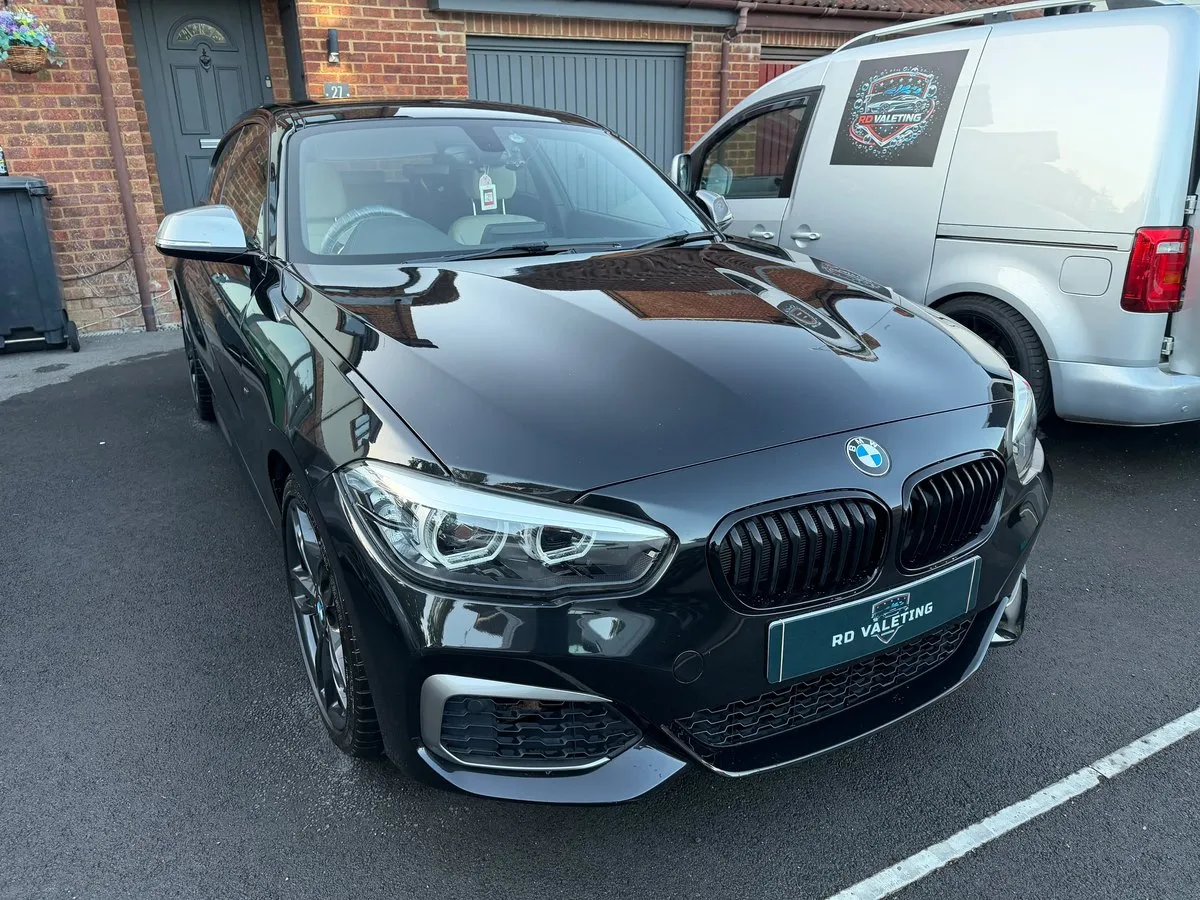 Black BMW M140i detailed by RD Valeting with the mobile valeting van behind it